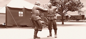 Still from animated film in sepia tones. With a large tent, tree, and a train in the background, two soldiers stand in the foreground. One, with one leg, lights a cigarette for the other, who is missing his arms.