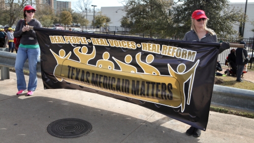 Marchers carry a My Medicaid Matters Banner.