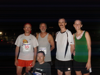 A group of runners pose for a photo.