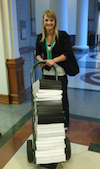 CTD Spring Intern Sydney Paschall prepares to wheel in one dolly full of petition
