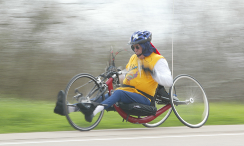 Male hand-cyclist on the road